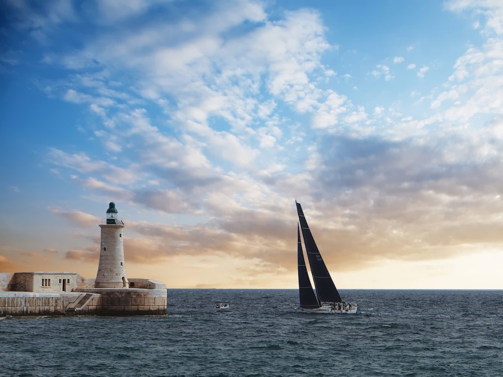 Malta lighthouse sailing yacht