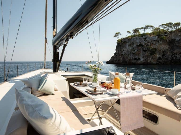 Sailing yacht anchored in front of a cliff coast Yacht charter and yacht charter holiday